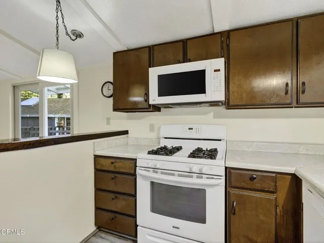 a kitchen with a stove and a microwave