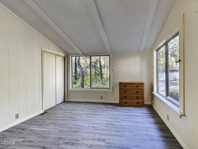 a view of room with window and wooden floor
