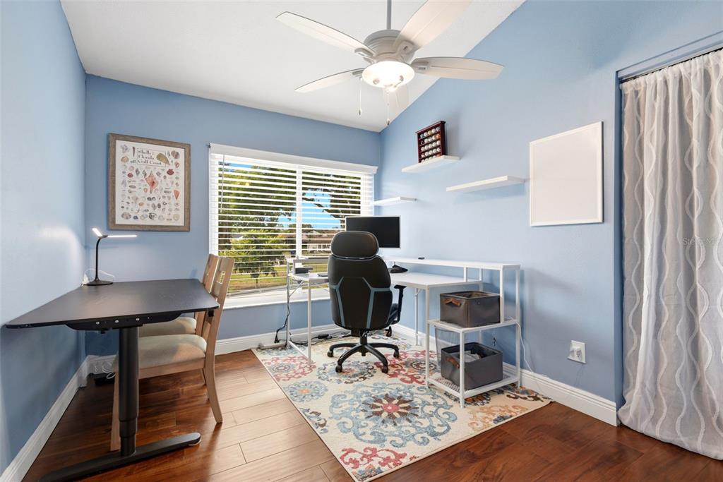 7432 Sparkling Lake Road Orlando, FL 32819 - Photo 8 of 54 a workspace with furniture and wooden floor