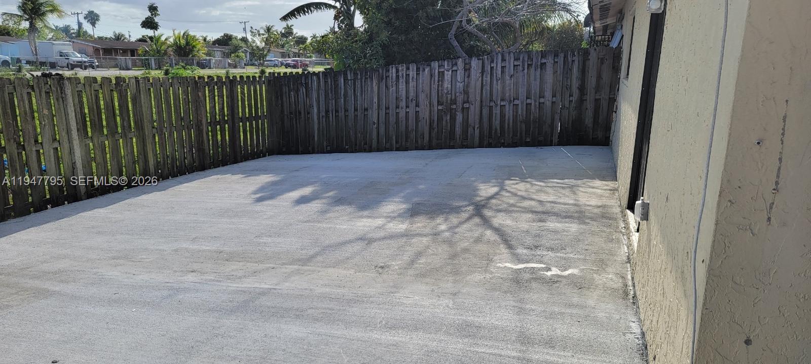 14242 Southwest 283rd Street Homestead, FL 33033 - Photo 2 of 7 a view of backyard with wooden fence