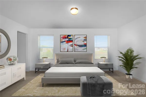 a bedroom with a bed and a potted plant