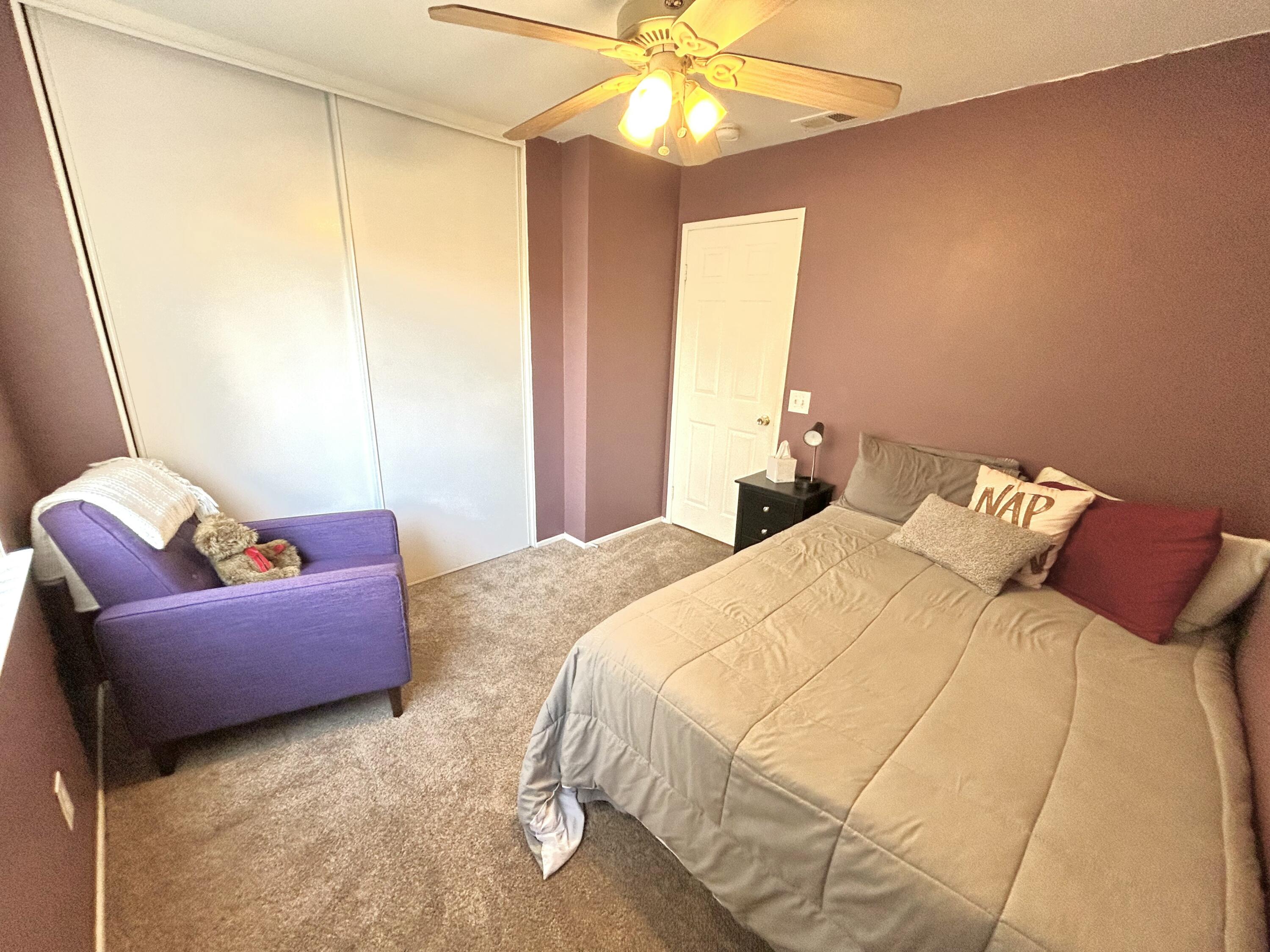 19940 Promenade Circle Riverside, CA 92508 - Photo 15 of 33 a bedroom with a bed and a chandelier