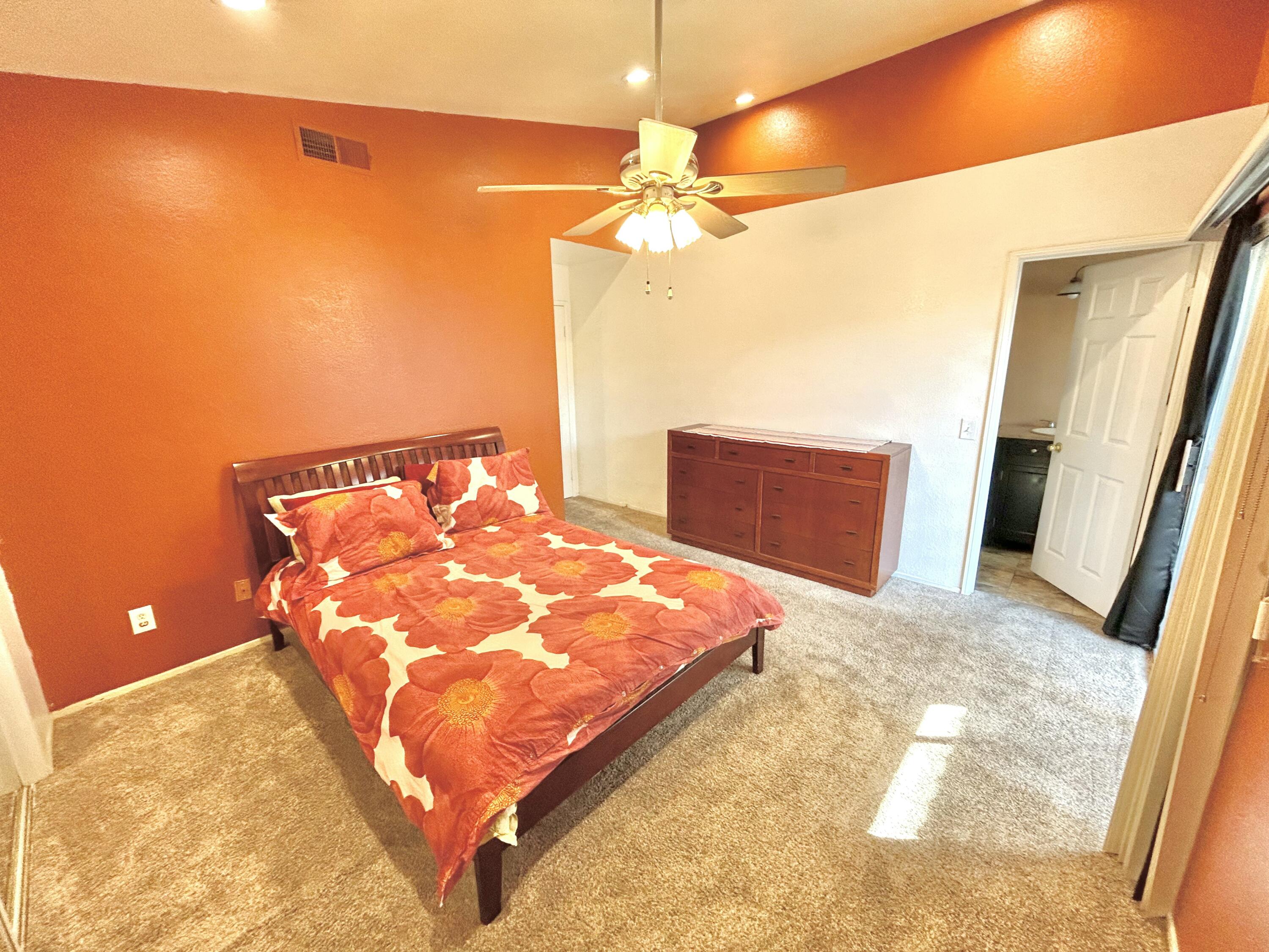 19940 Promenade Circle Riverside, CA 92508 - Photo 21 of 33 a bedroom with a bed and a chandelier