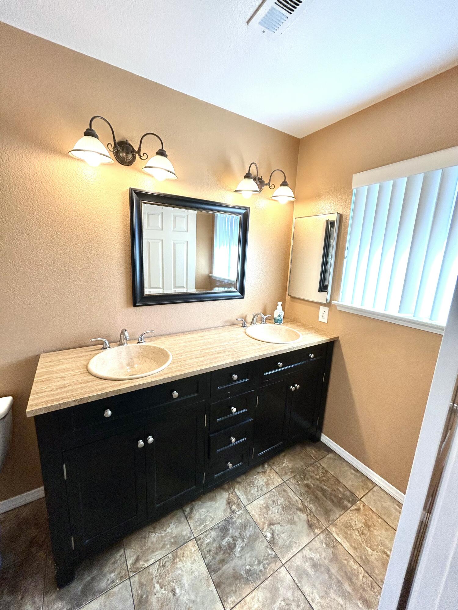 19940 Promenade Circle Riverside, CA 92508 - Photo 23 of 33 a spacious bathroom with a double vanity sink and a mirror