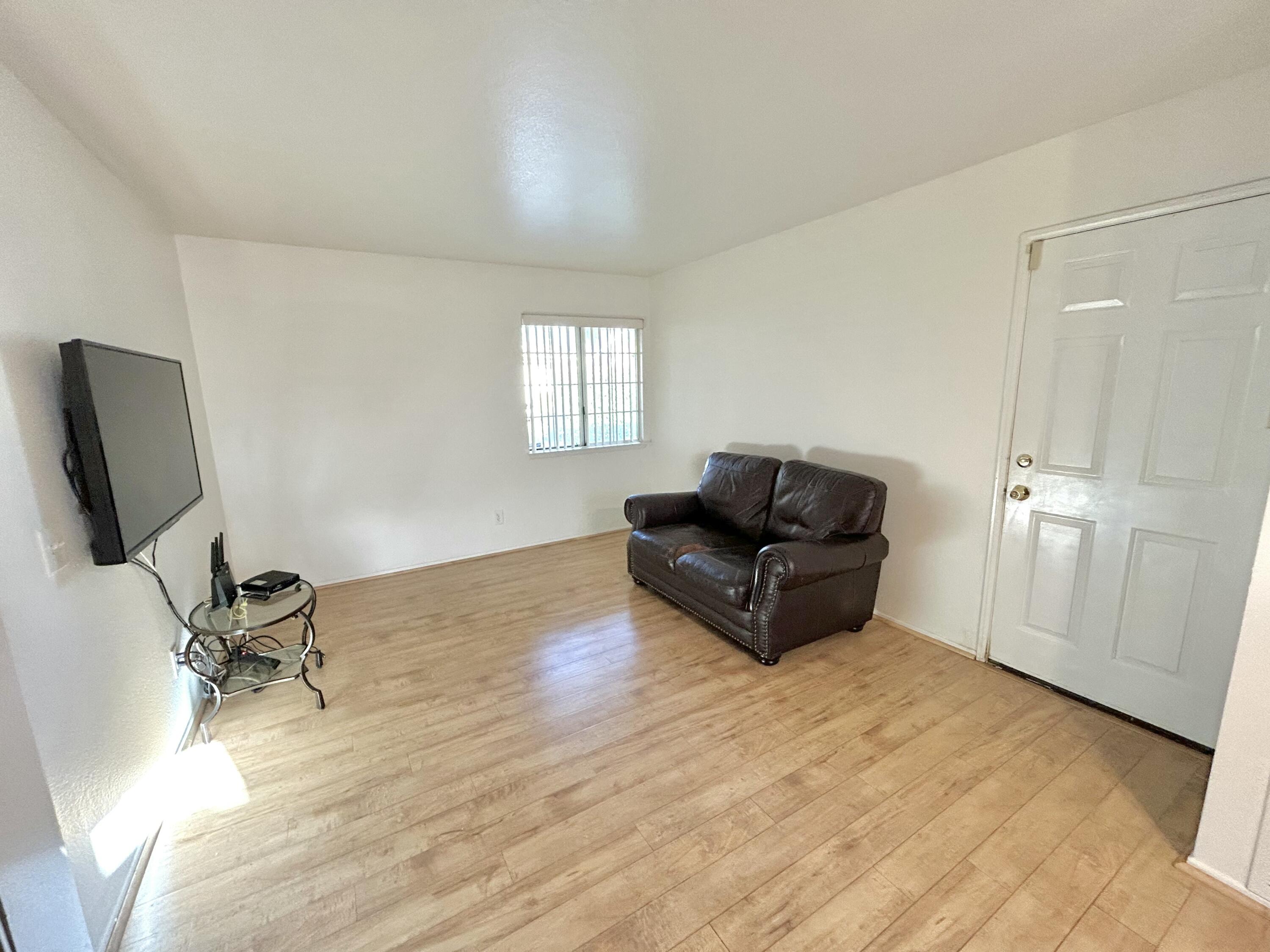 19940 Promenade Circle Riverside, CA 92508 - Photo 27 of 33 a living room with furniture and a flat screen tv