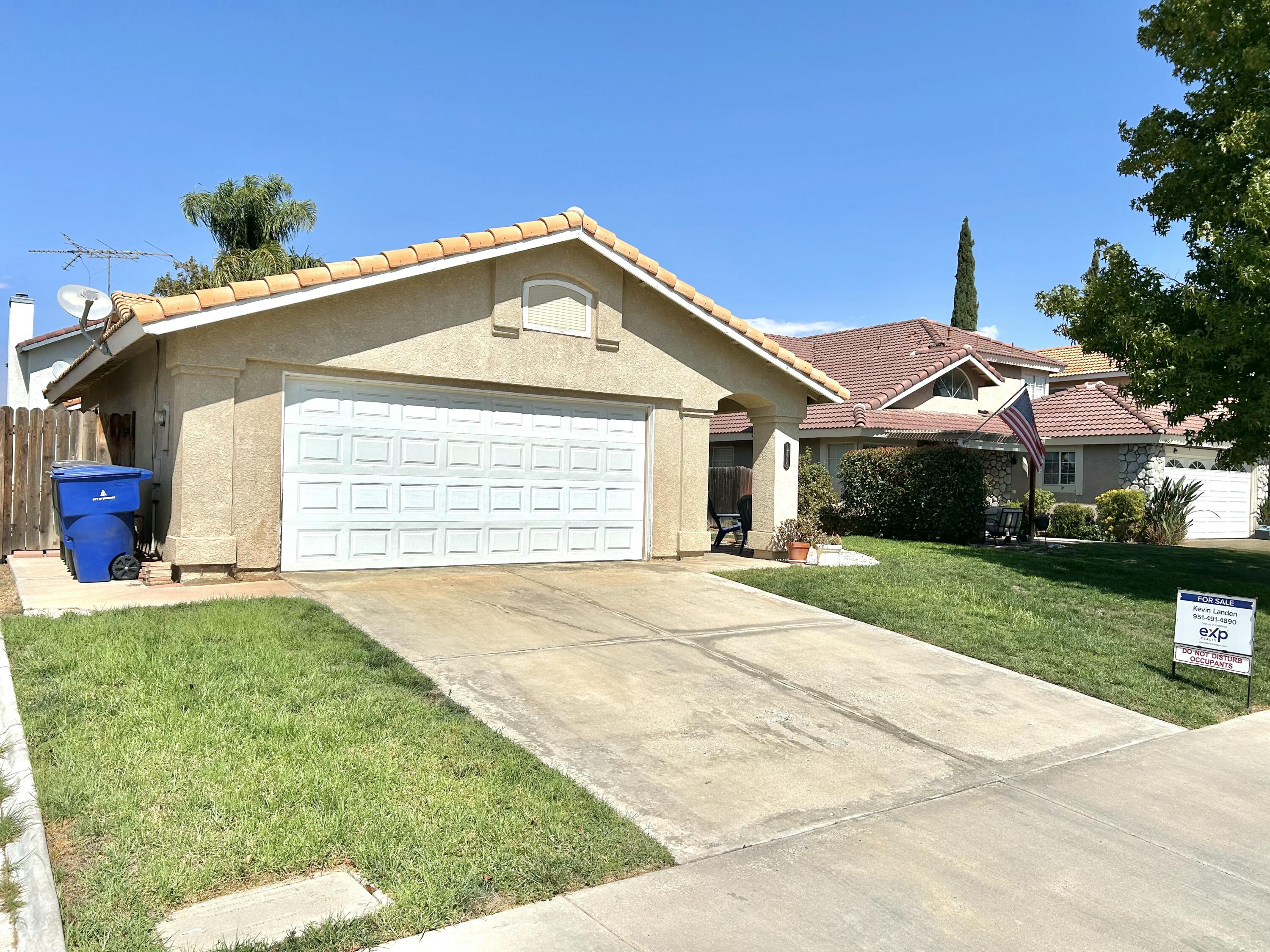 19940 Promenade Circle Riverside, CA 92508 - Photo 4 of 33 a front view of a house with a yard