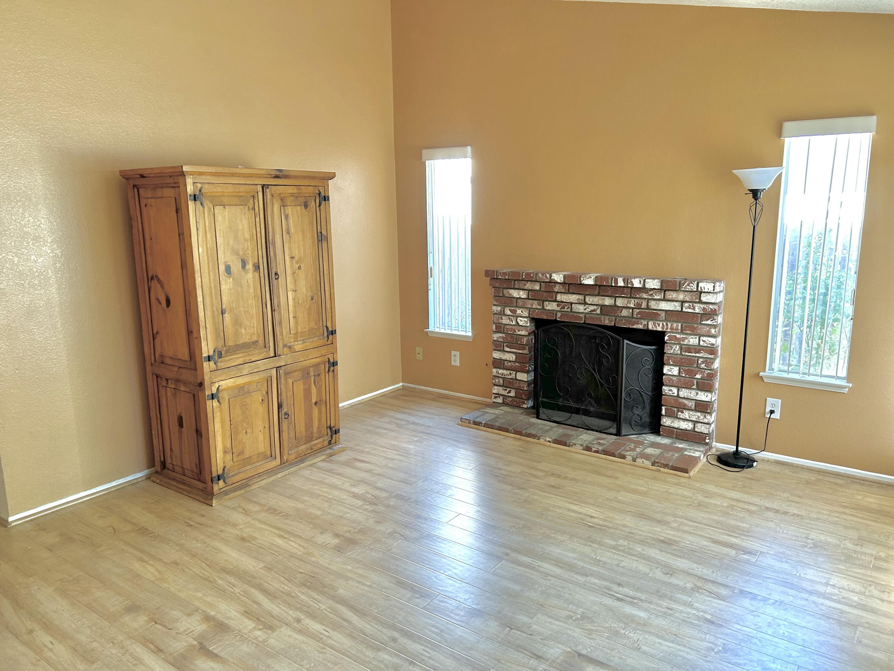 19940 Promenade Circle Riverside, CA 92508 - Photo 9 of 33 a view of a livingroom with wooden floor and a fireplace