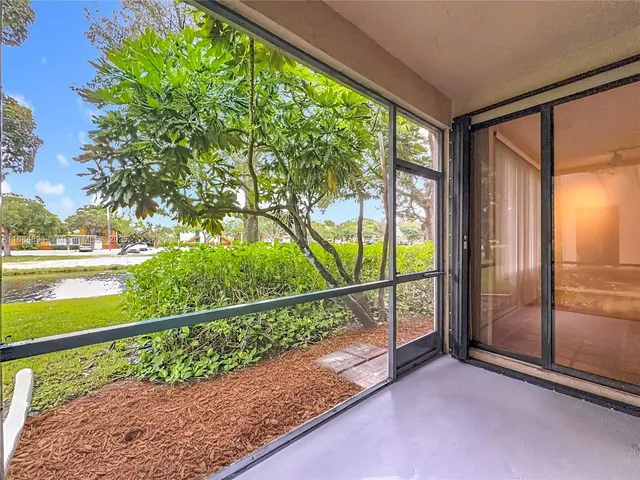 a view of a livingroom with a space & a ceiling fan