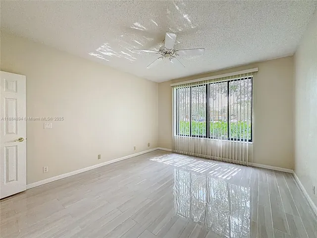 a view of a swimming pool with a garden and deck