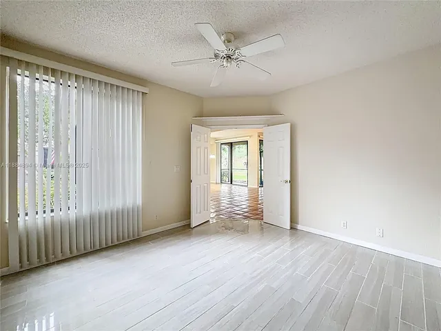 a view of a swimming pool with a patio and a garden