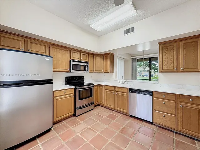 a view of a room with a window and chandelier fan