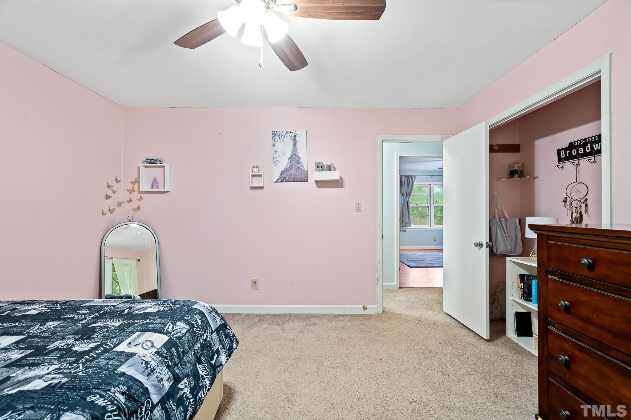 8808 Red Oak Court Raleigh, NC 27613 - Photo 11 of 34 a bedroom with a bed and a dresser