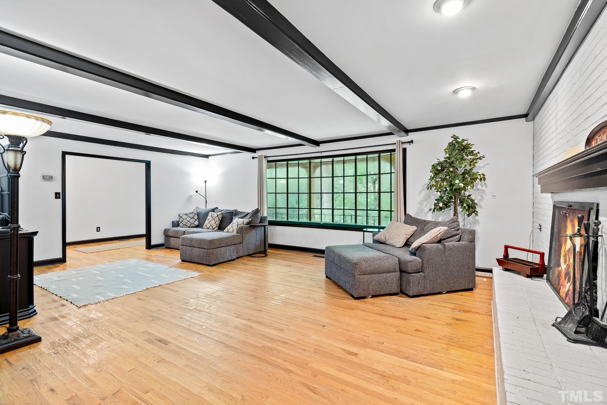 8808 Red Oak Court Raleigh, NC 27613 - Photo 20 of 34 a living room with furniture window and a wooden floor