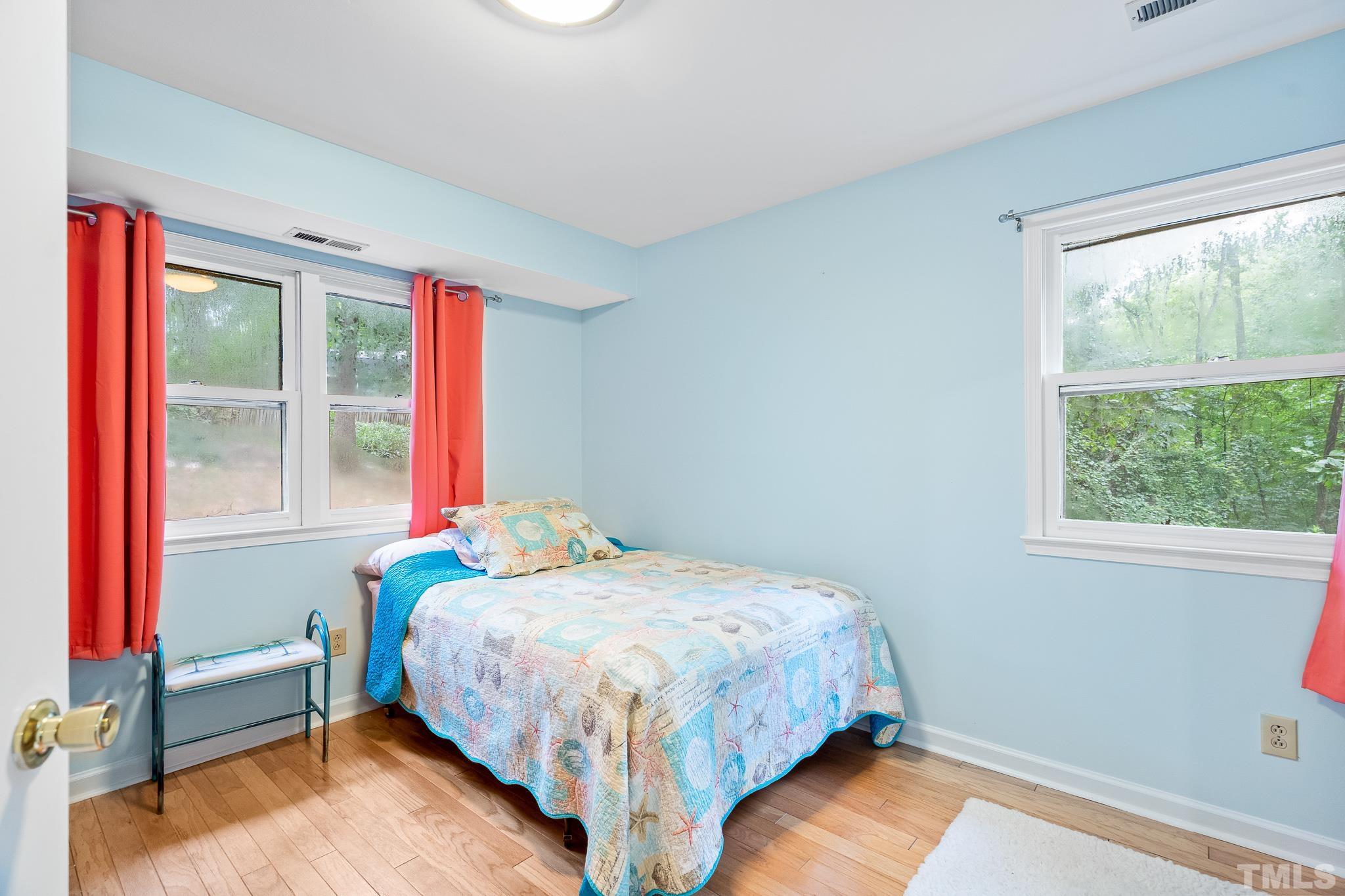 8808 Red Oak Court Raleigh, NC 27613 - Photo 2 of 34 a bedroom with a bed and a window