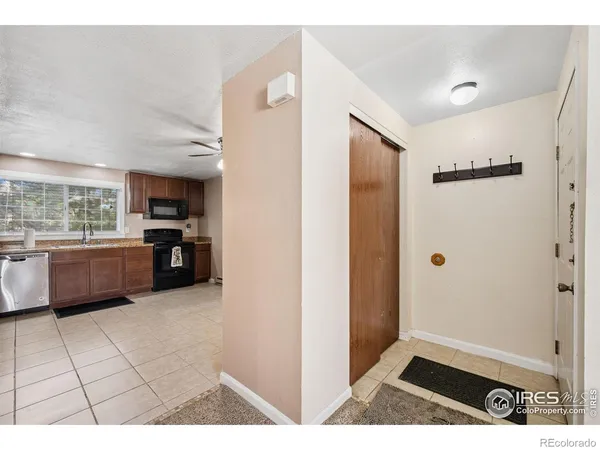 a open kitchen with a refrigerator and a sink