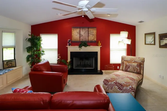 a living room with furniture a fireplace and a window