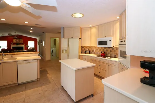 a kitchen with white cabinets and white appliances