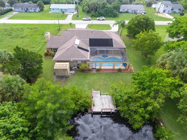 an aerial view of a house with garden space and street view