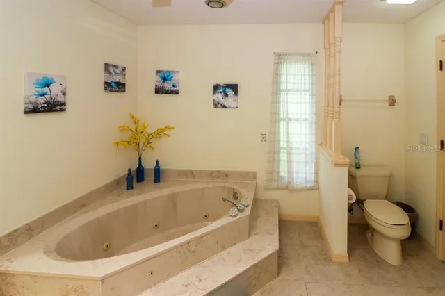 a white bath tub sitting next to a toilet
