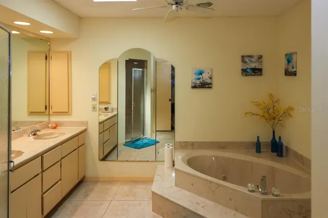 a bathroom with a tub sink and mirror