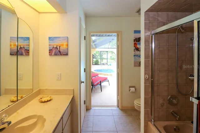 a bathroom with a tub sink and mirror