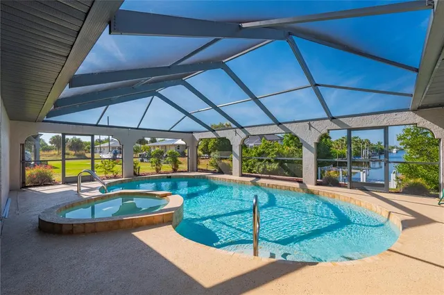 a view of a backyard with swimming pool