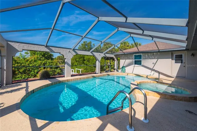 a view of a backyard with table and chairs under an umbrella