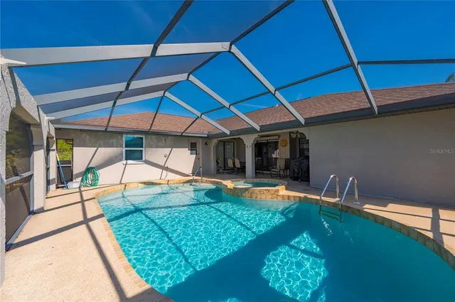 an outdoor space with pool and furniture