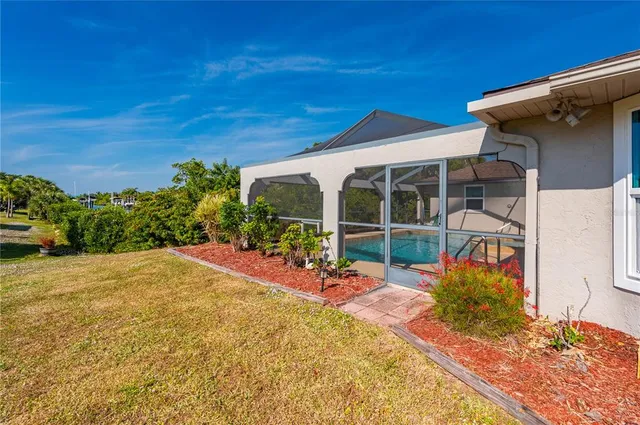 a view of a backyard with plants and a patio