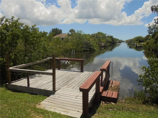 a terrace of a house with wooden floor and outdoor seating