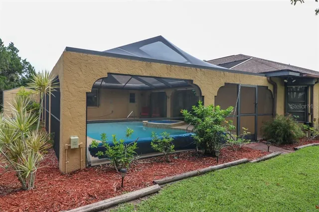 a terrace of a house with wooden floor and outdoor seating