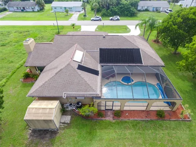 an aerial view of a house with yard