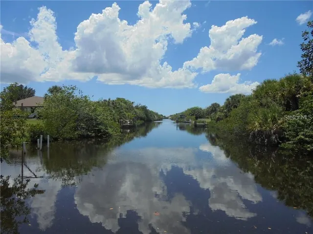 a view of a lake with houses in back
