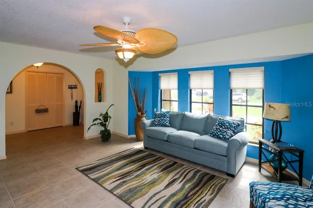 a living room with furniture a lamp and a chandelier