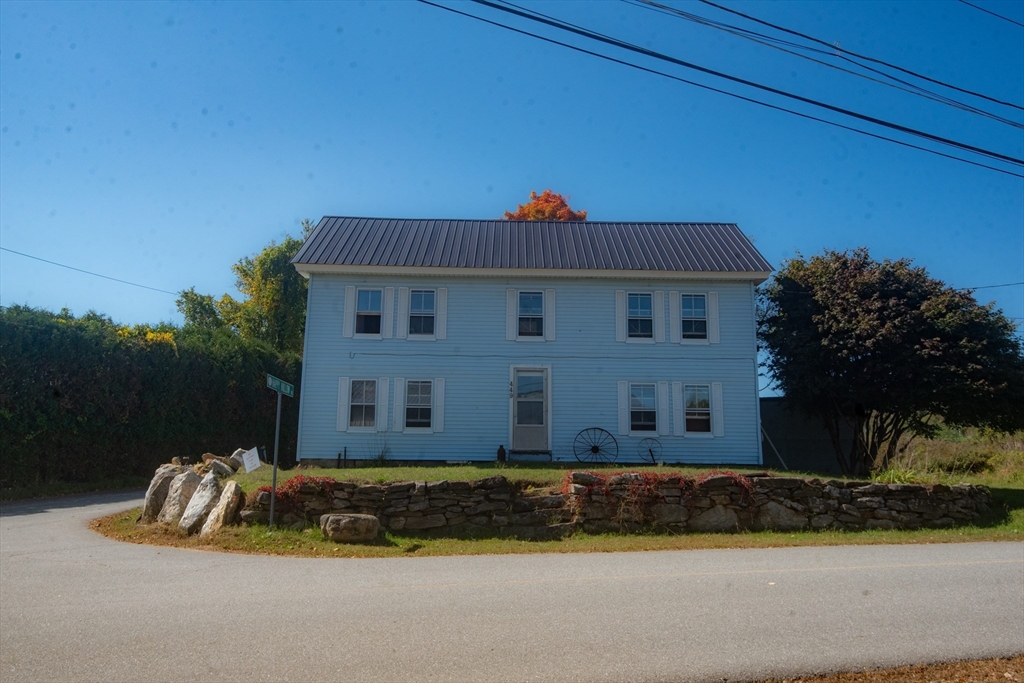 a view of a house with a backyard