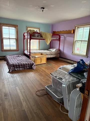 a bedroom with furniture and a window