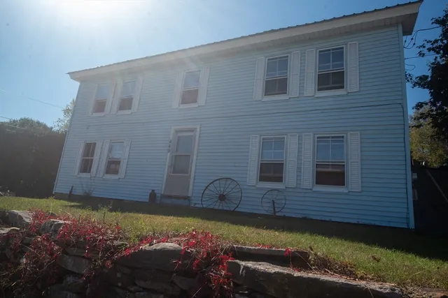 a view of a house with a yard