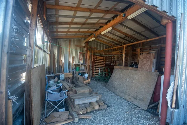 a building outdoor space with patio furniture and potted plants
