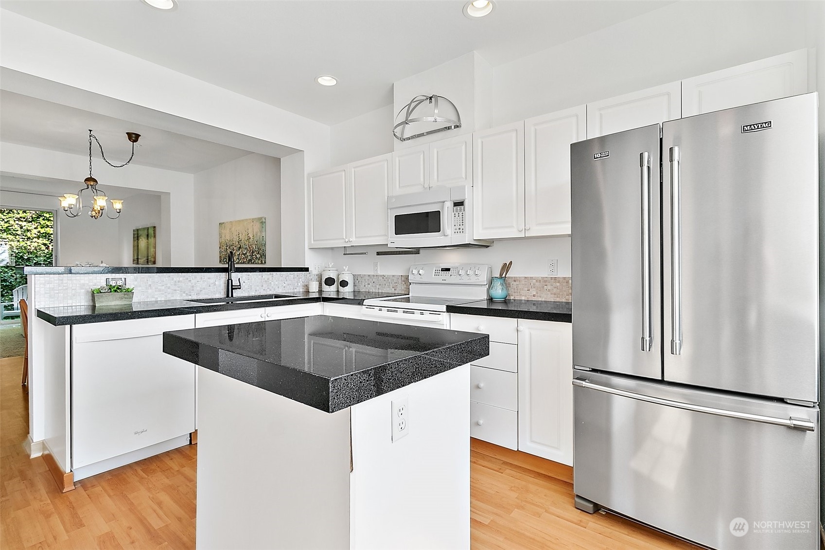2300 Benson Road South, Unit E2 Renton, WA 98055 - Photo 11 of 35 a kitchen with kitchen island a sink cabinets and refrigerator