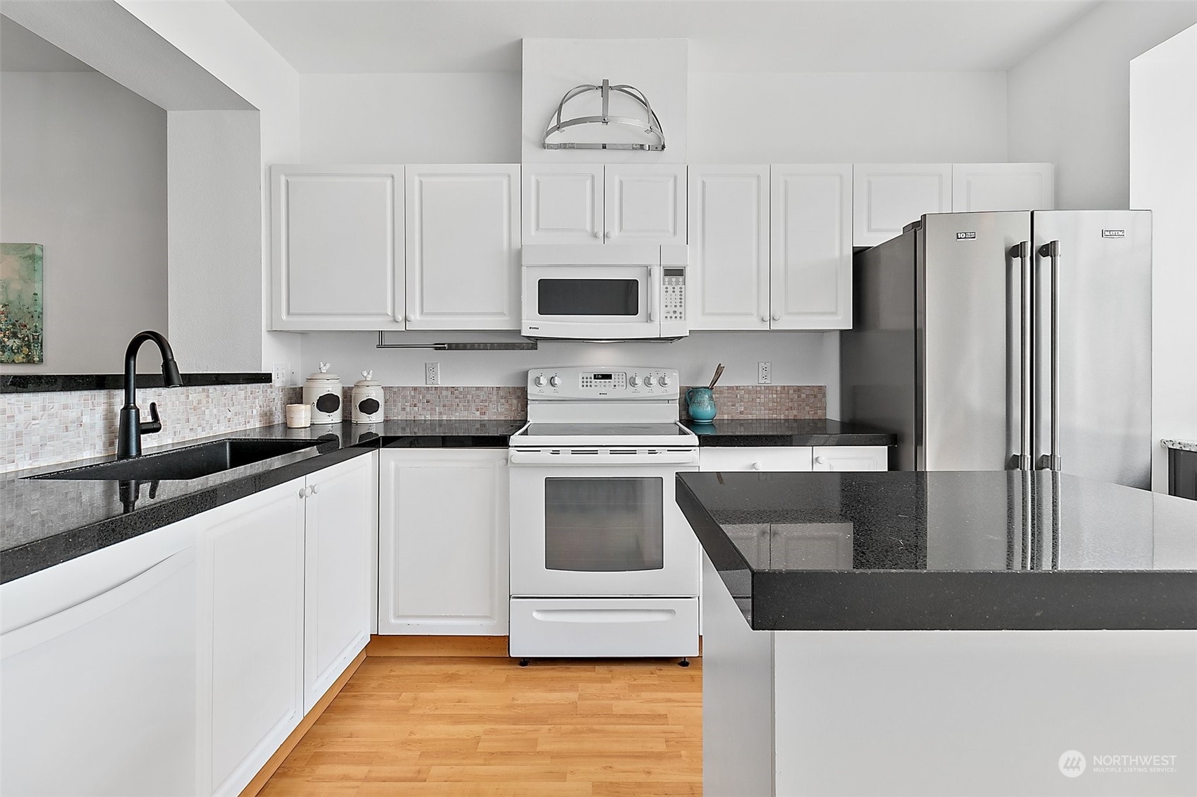 2300 Benson Road South, Unit E2 Renton, WA 98055 - Photo 13 of 35 a kitchen with stainless steel appliances a stove a sink and a refrigerator