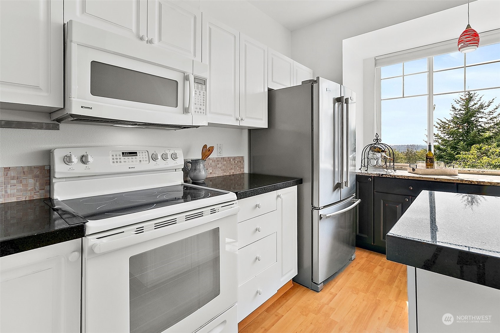 2300 Benson Road South, Unit E2 Renton, WA 98055 - Photo 15 of 35 a kitchen with stainless steel appliances white cabinets and a refrigerator