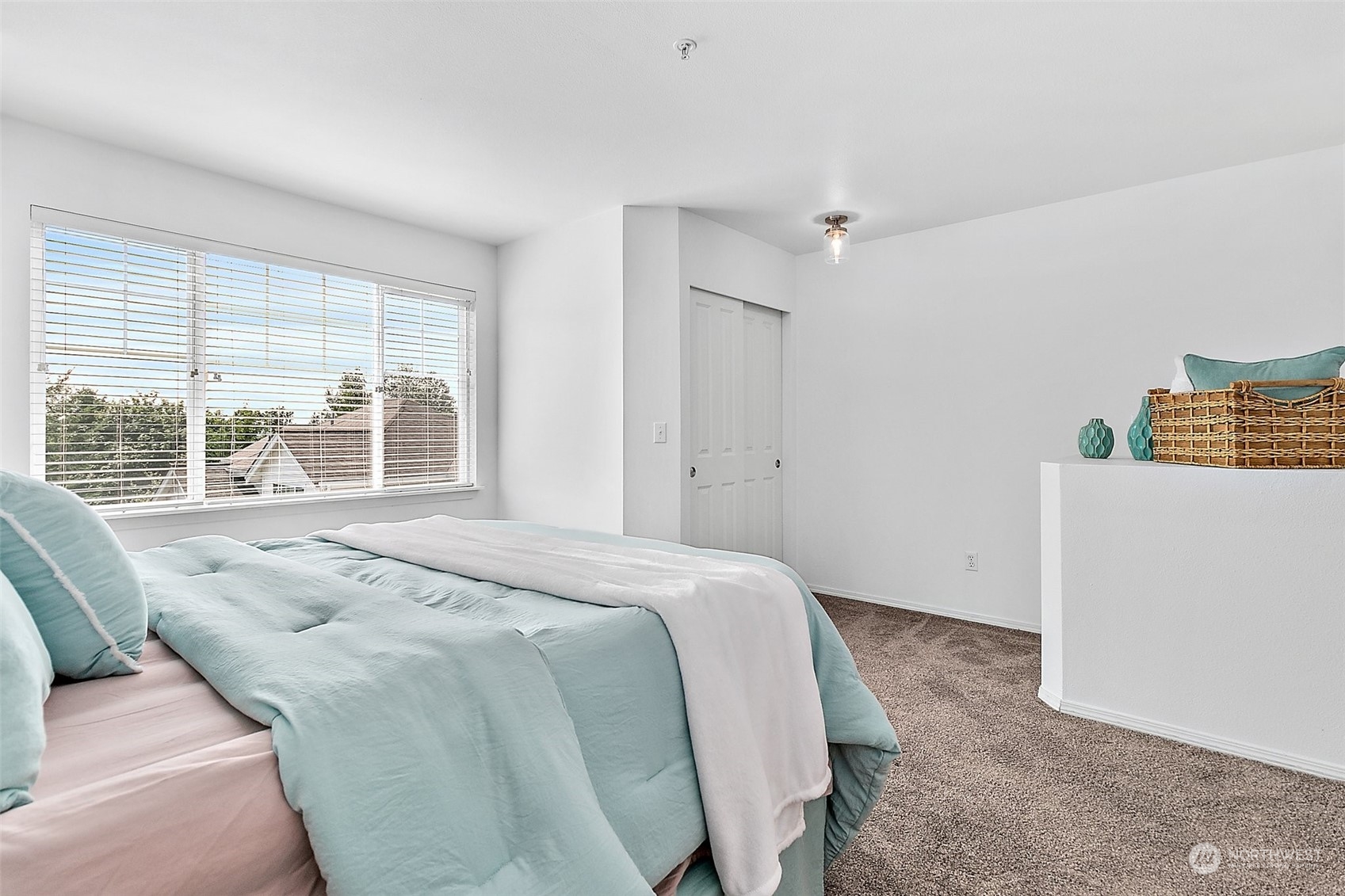 2300 Benson Road South, Unit E2 Renton, WA 98055 - Photo 27 of 35 a spacious bedroom with a bed and a large window