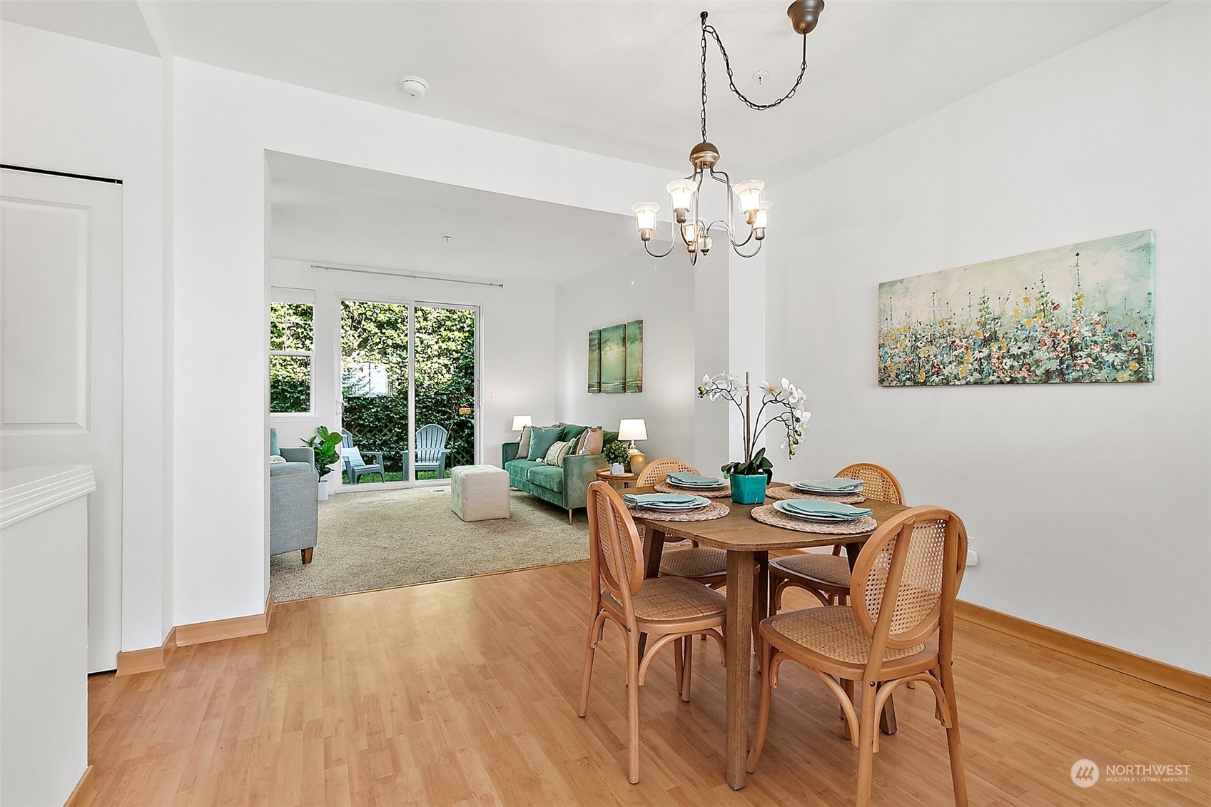2300 Benson Road South, Unit E2 Renton, WA 98055 - Photo 5 of 35 a dining room with furniture a chandelier and wooden floor