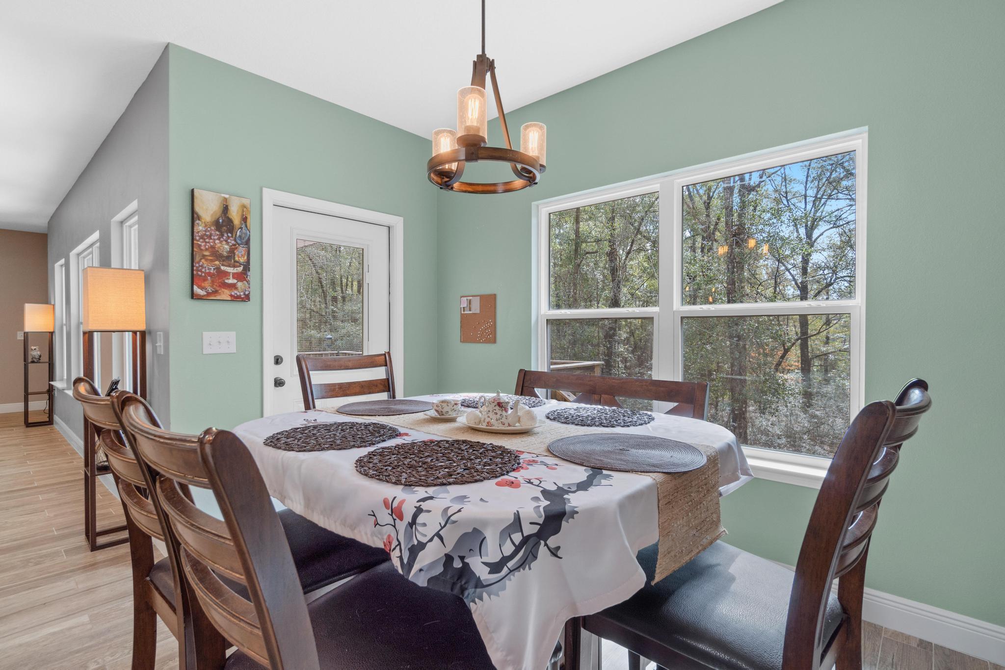 3586 Randy Drive Crestview, FL 32539 - Photo 17 of 42 a dining room with furniture a chandelier and window