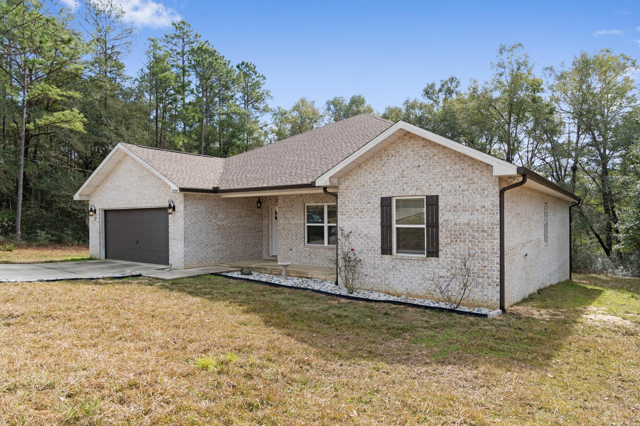 3586 Randy Drive Crestview, FL 32539 - Photo 2 of 42 a view of an house with backyard space and garden
