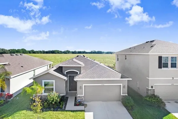an aerial view of a house with a ocean view