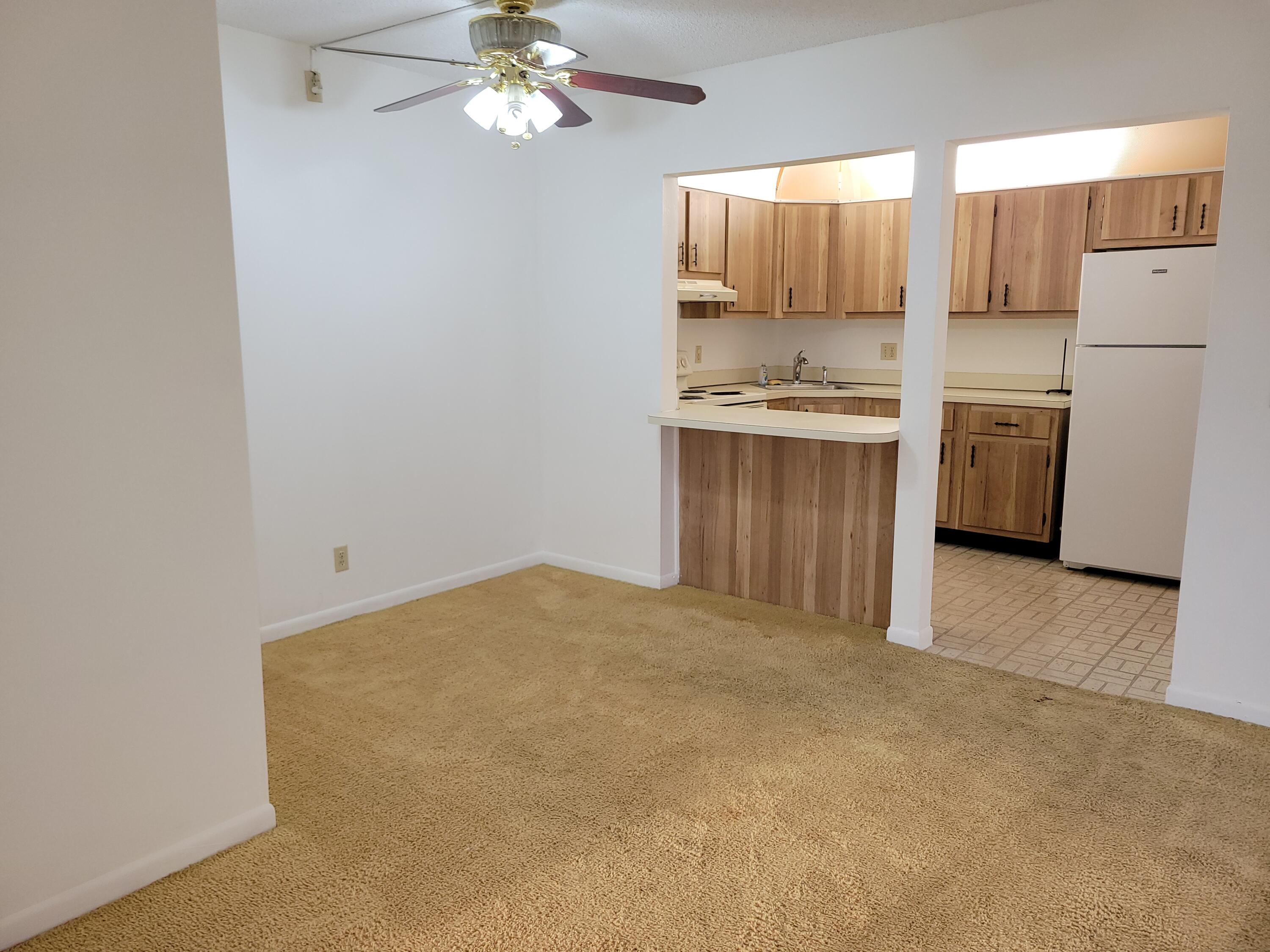 302 Pine Ridge Circle, Unit D2 Greenacres, FL 33463 - Photo 3 of 20 a view of kitchen and empty room with fireplace