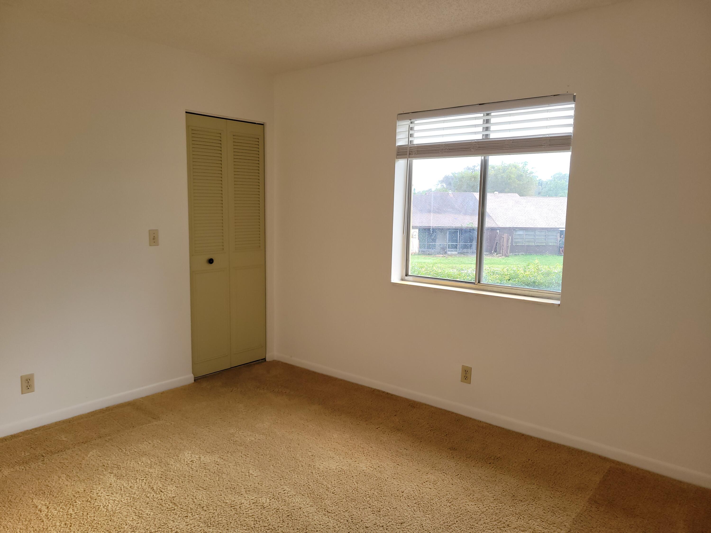 302 Pine Ridge Circle, Unit D2 Greenacres, FL 33463 - Photo 5 of 20 an empty room with a window