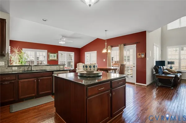 a kitchen with stainless steel appliances granite countertop a sink stove and cabinets