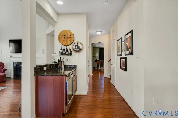 a living room with furniture rug and wooden floor